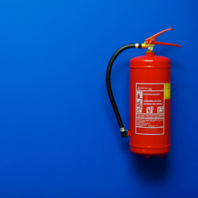 Fire extinguisher on the blue wall